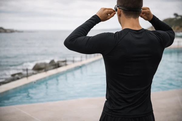 Men’s long sleeve compression rash guard prepared for water-based training activity