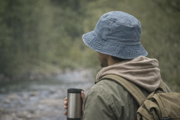 Washed denim bucket hat worn in a casual outdoor environment